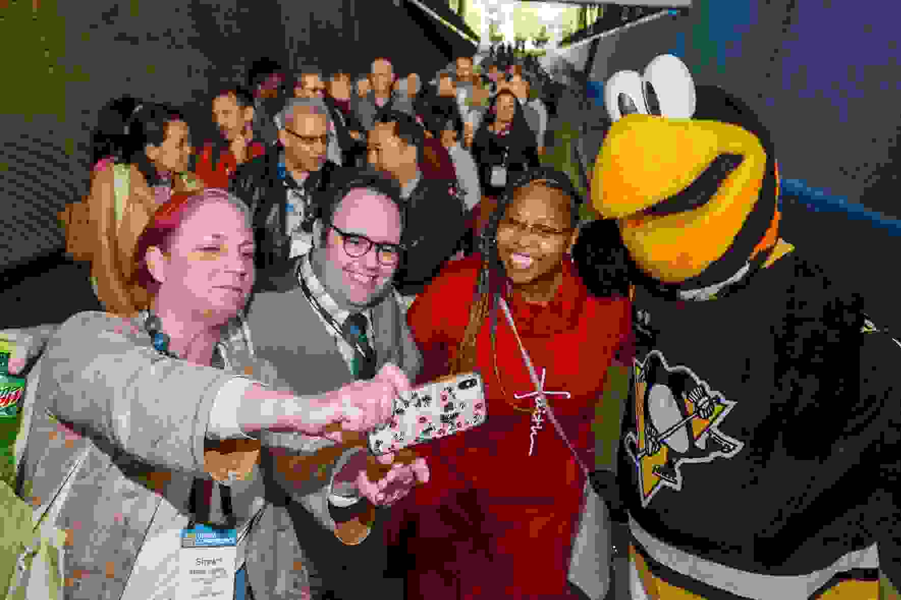 Attendees posed with Iceburgh, mascot of the Pittsburgh Penguins, at the Host Company Reception (photo: David Bachman Photography)